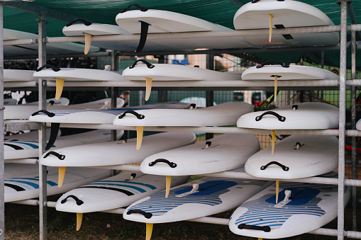 A rack full of colorful surfboards, secured and stored, stands by for the next wave of aquatic adventures