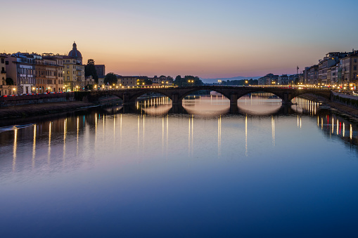 Ponte Santa Trinita Bridge on Arno River in Florence, Tuscany Italy at Dusk Under Clear Skies