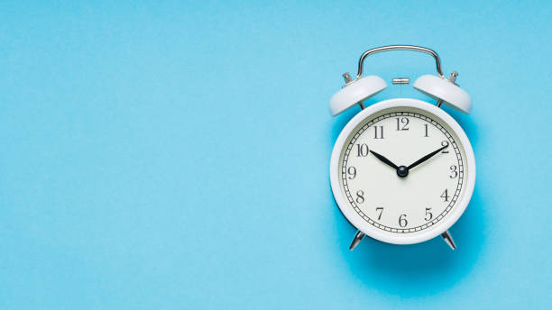 istock White Alarm Clock on Blue Background, Time Concept, Copy Space 1848268244