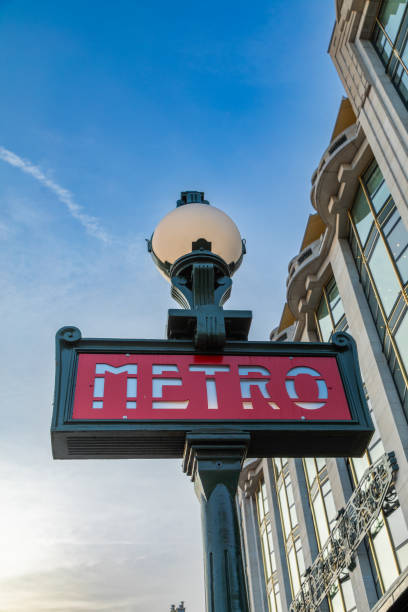 Metro sign with lamp at dusk in Paris