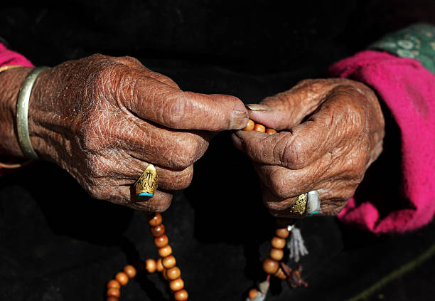 istock Women with Prayer beads 184831658