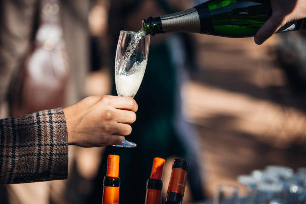 istock Man pouring champagne into a glass at an event 1848319166