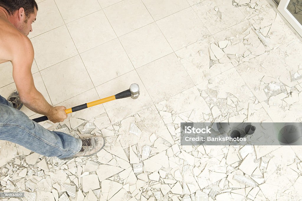 Trabalhador de Construção com martelo de forja para quebrar piso de cerâmica - Foto de stock de Escombros - Material royalty-free