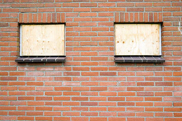 istock Two windows closed with plywood 184832213
