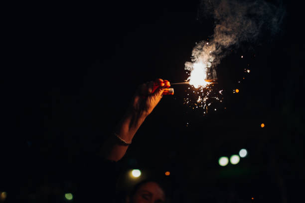 istock A man holds a sparkler in complete darkness at a celebration 1848322269