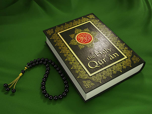 The Holy Quran The Muslim Holy book Quran (or Koran) and prayer beads standing on green fabric.Similar: muhammad prophet photos stock pictures, royalty-free photos & images