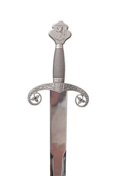 The hilt and pommel of a medieval sword isolated on a white background