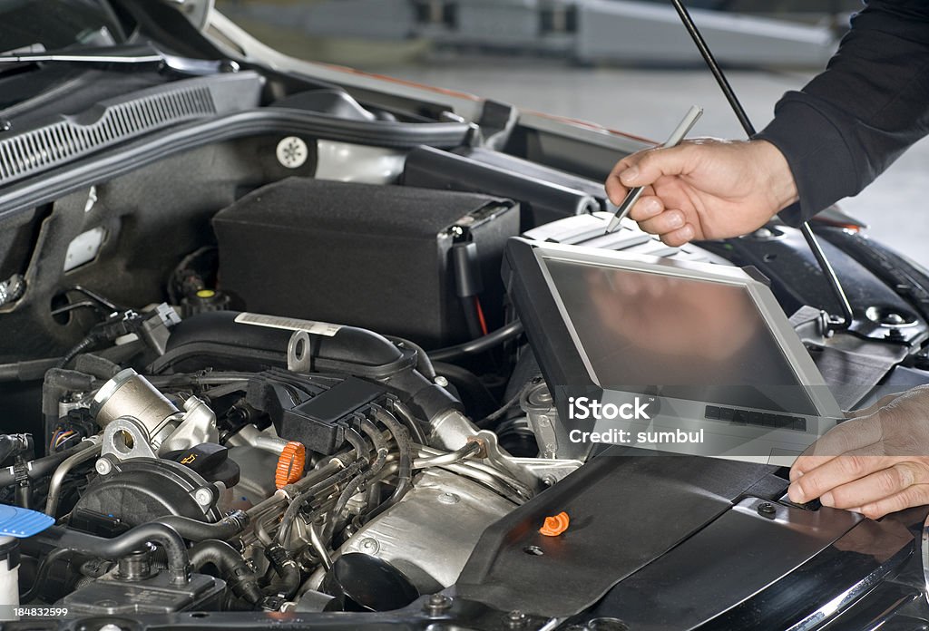 Repairing Car with computer  Adjusting Stock Photo