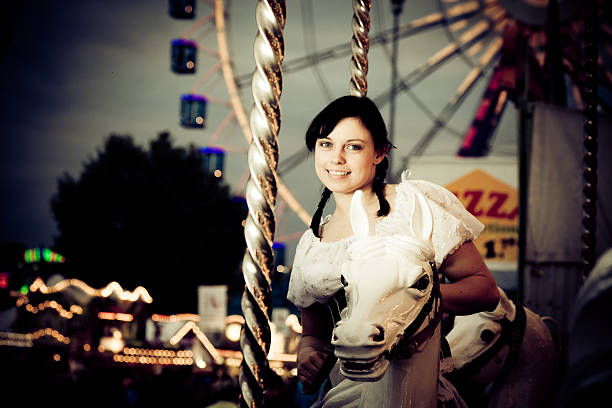istock young woman enjoying a carousel ride 184832803