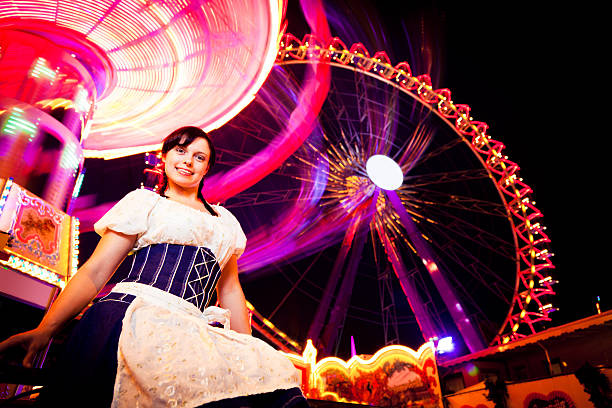 istock young woman standing next to brightly colored carousel 184832853