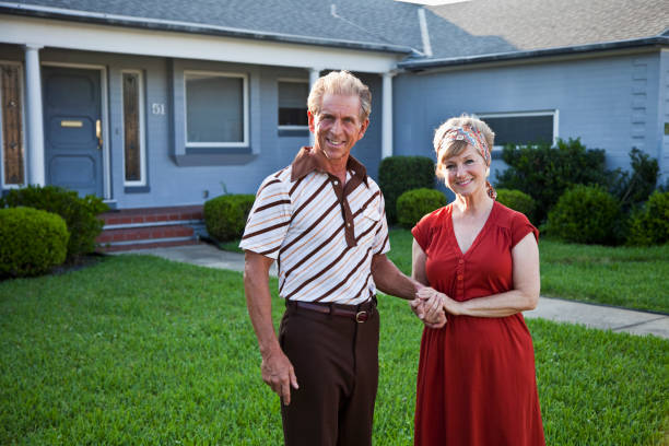 istock Senior couple standing outside house 184832895
