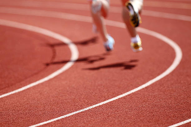 istock Racing runners against the oval track 184832910