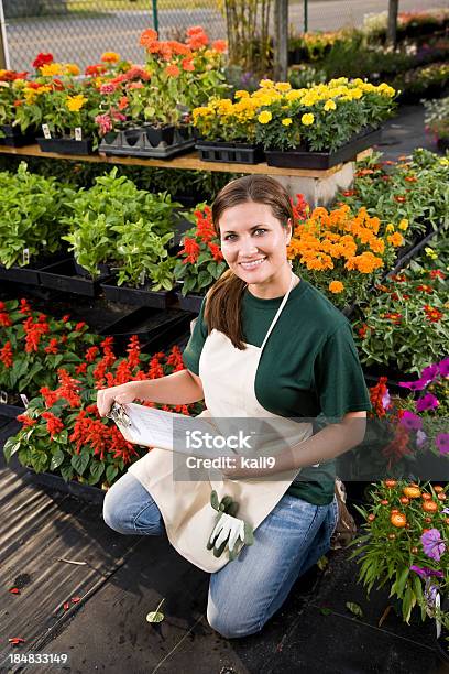 Worker Taking Inventory In Retail Garden Center Stock Photo - Download Image Now - 20-29 Years, 25-29 Years, Adult