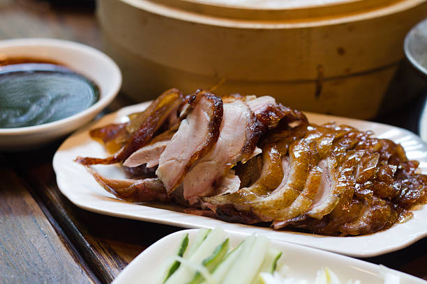 Beijing roasted sliced duck dinner on white plate with sides stock photo