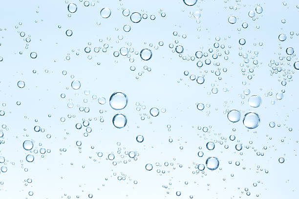 many small bubbles on sky blue background - bel vloeistof fotos stockfoto's en -beelden