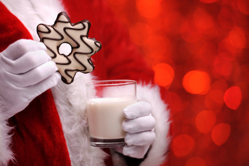 Santa holding christmas cookie and milk with copy space - XXXL Image