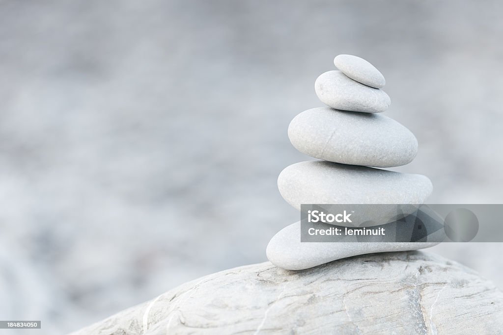 Pebbles, balance and Zen Pile of pebble stones on a beach. Ideal image for relaxation and zen like designs. Balance Stock Photo