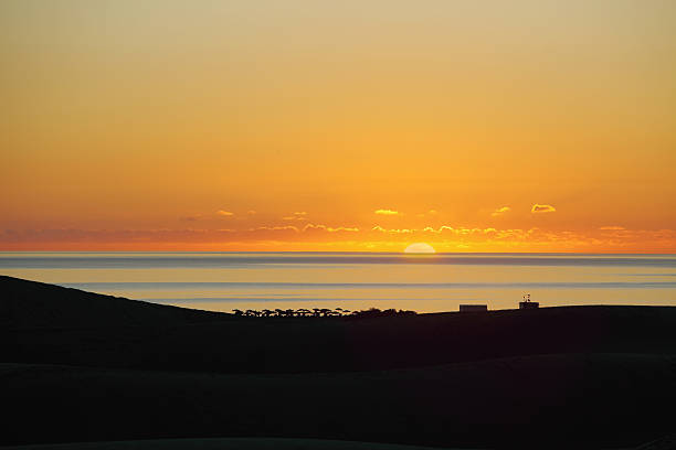 istock sunrise at Maspalomas Playa de Ingles on Gran Canaria 184834234
