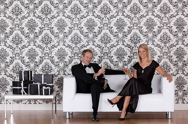 istock Couple enjoying champagne on a couch 184834272