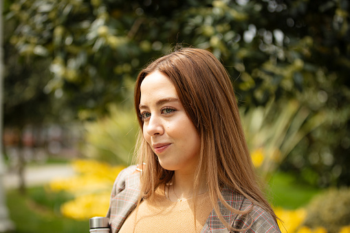 Young woman portrait at public park in springtime.