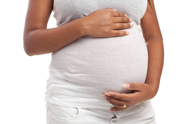 istock woman stroking her pregnant  belly. 184834490