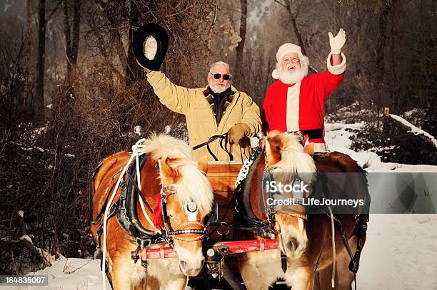 Santa And His Helper Driving A Team Of Horses Stock Photo - Download Image Now - Santa Claus, Animal Sleigh, Cowboy