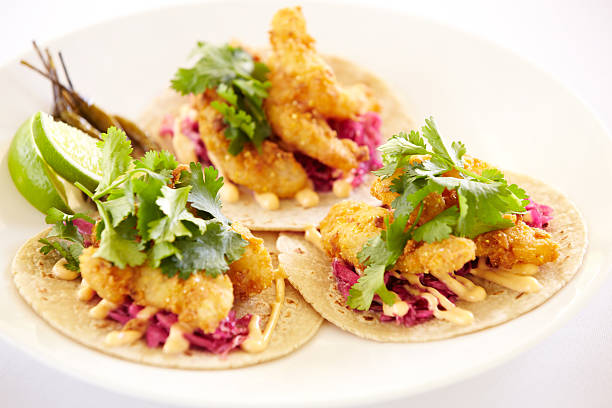 Griddled mahi fish tacos, cilantro and lime on corn tortillas