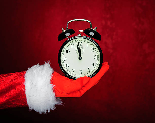 istock santa hand holding vintage clock 184835105