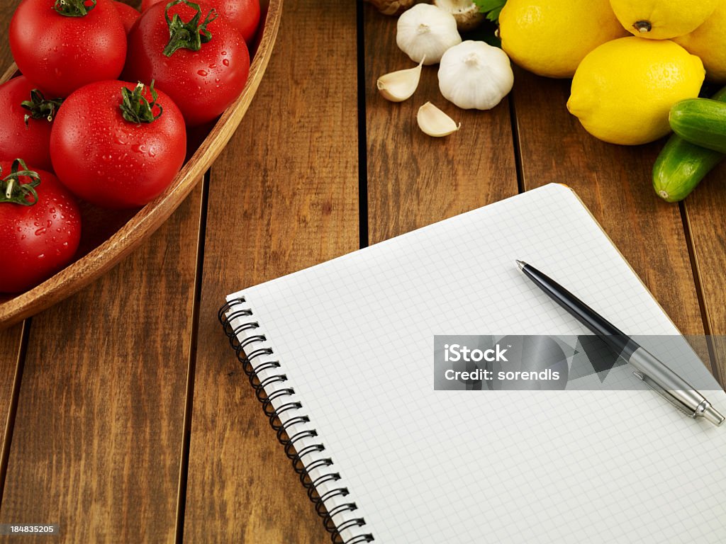 Foodmarket List Low angle view of a notebook on wooden table with vegetables Abundance Stock Photo