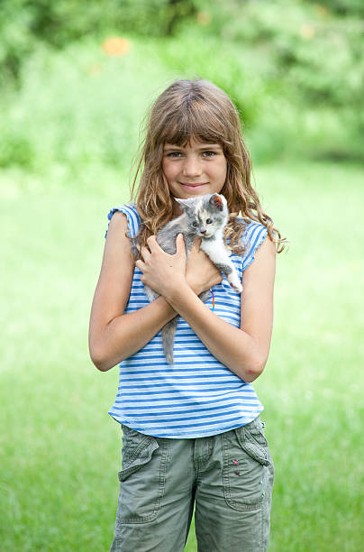 istock Cute Young Girl Holding Kitten 184835241