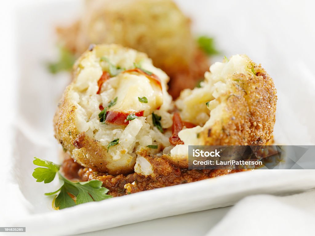 Arancini - Wikipedia "Deep Fried Risotto Balls Stuffed with Fresh Italian Parsley, Mozzarella Cheese and Roasted Red Peppers in a Tomato Pesto Sauce-Photographed on Hasselblad H1-22mb Camera" Suppli Al Telefono Stock Photo