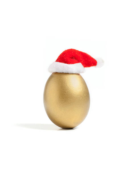 Golden egg in a little Santa's hat stock photo