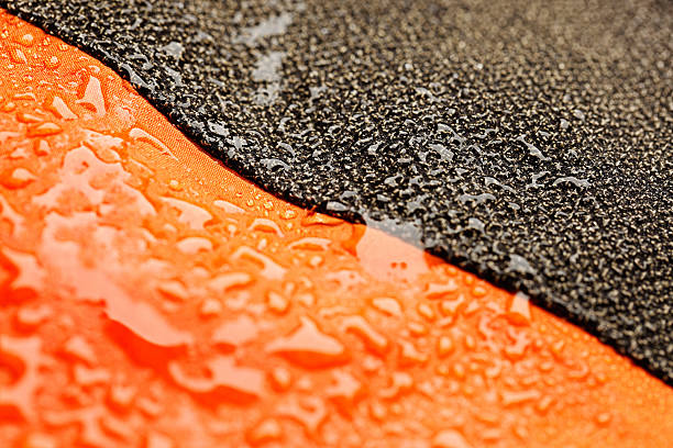 Waterproof textile after rain - covered with water drops "Waterproof textile  with water droplets. Close - up, macro. Very shallow DOF. The grain and texture added.SEE ALSO:" polyester photos stock pictures, royalty-free photos & images