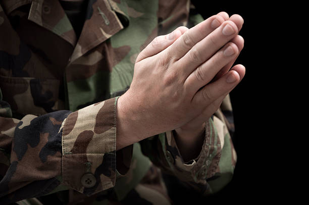 istock Hands of a Praying Soldier 184836086