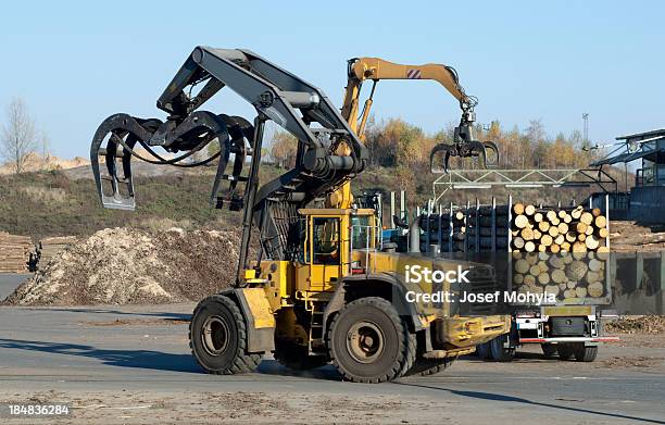 Unloading Of Logging Truck Stock Photo - Download Image Now - Mechanical Grabber, Machinery, Lumber Industry