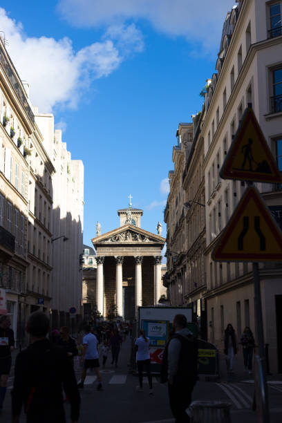 paris, france: pedestrians and notre dame de lorette church - notre dame de lorette imagens e fotografias de stock