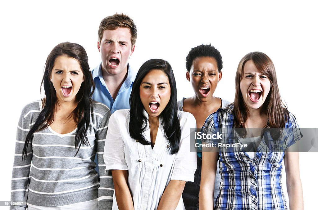 Five young people shouting at camera "Five young people shout. Could be in encouragement, support or anger. Isolated on white." Activity Stock Photo