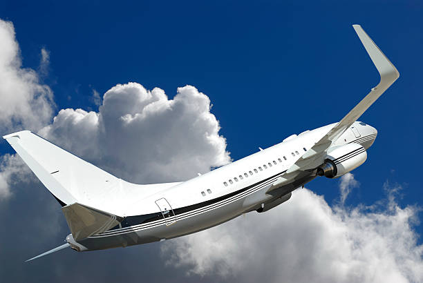 istock Passenger jet banking against cumulus cloud 184836616