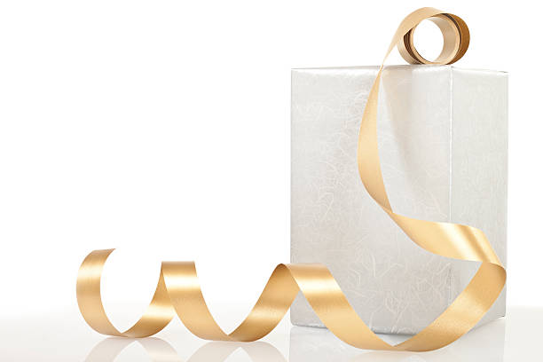 Gold foil Christmas decorations on a wooden background.