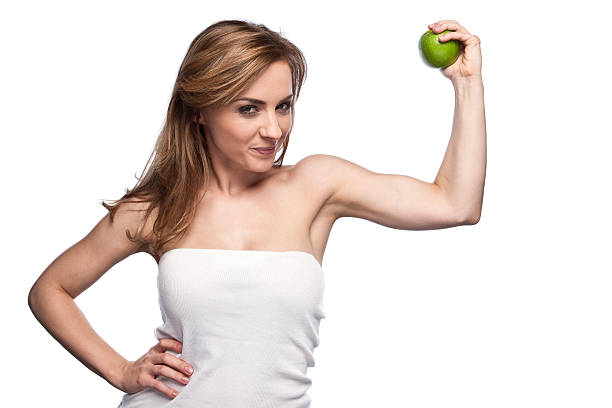 istock Beautiful young woman on white background holding an apple 184836775