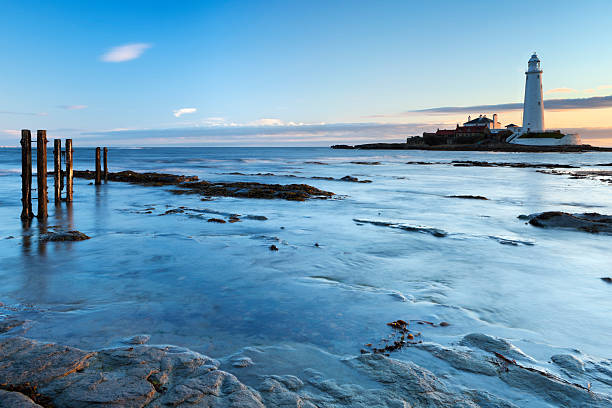 High tide coming in over the path towards St. Mary's Lighthouse, Whitley Bay, England. Photographed at sunrise.