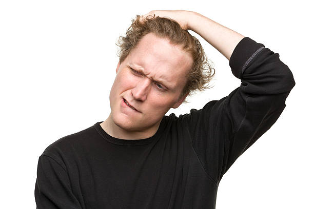istock Confused Young Man Scratches Head 184837036
