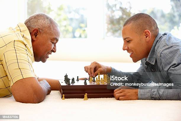 Senior Man Playing Chess With Son Stock Photo - Download Image Now - Senior Adult, Chess, Playful