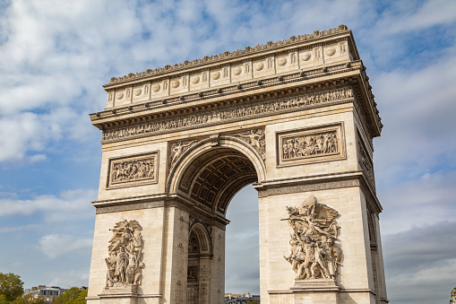 Low-angle view of Arc de Triomphe on The Place Charles de Gaulle in Paris, France.