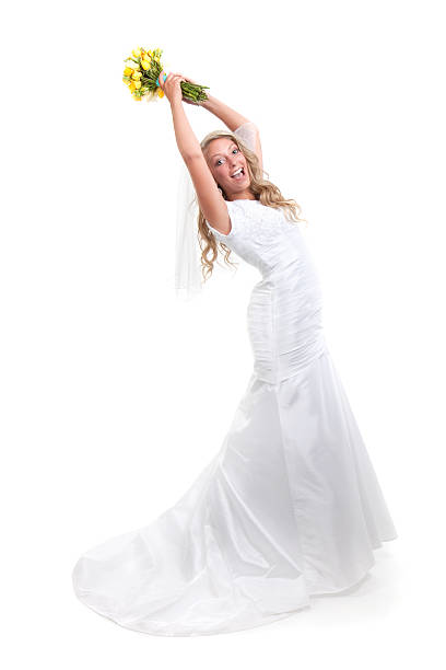 Beautiful bride on white background about to throw a yellow bouquet of flowers.