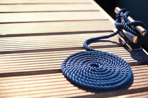 steel pier cleat and a blue mooring rope, shallow DOF