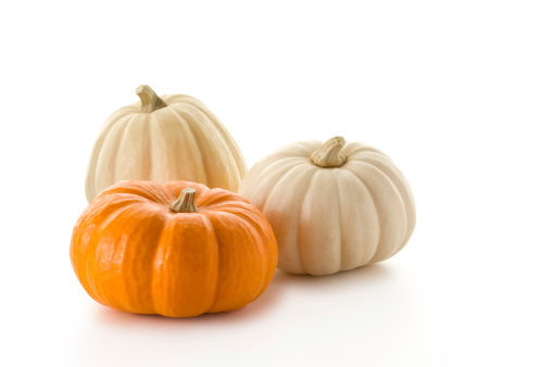 Three mini pumpkins on white.