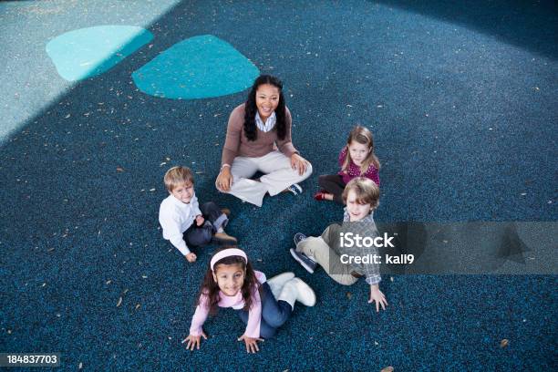 Preschoolers Sitting In Circle With Teacher Stock Photo - Download Image Now - Circle, Teacher, Preschool Student