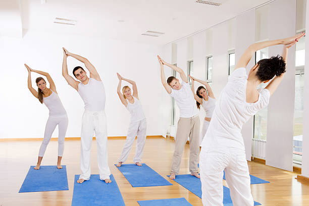 istock Group of people  doing yoga exercises with instructor 184837851