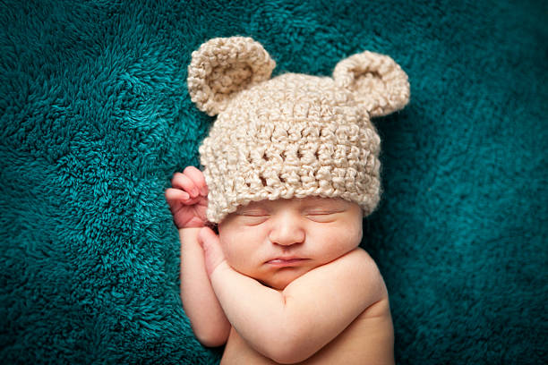 Newborn Baby Boy Sleeping Peacefully Wearing Knit Hat